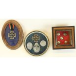 Three mounted displays of WWII German interest, including 1939 Iron Cross, various breast badges