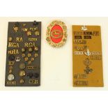 Three mounted displays of British Military shoulder titles, buttons, cap badges, etc including