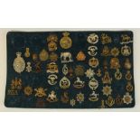 Framed and mounted display of approx fifty one British military cap badges including Royal
