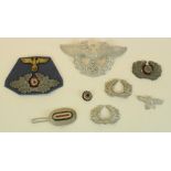 Selection of German WWII Third Reich metal peak cap badges to include Luftwaffe etc.