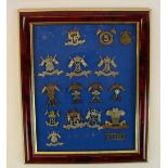 Framed and mounted display of Lancers British military cap badges (some possible re-strikes)