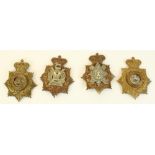 Four British military helmet badges, including Liverpool & Durham Light Infantry (possible re-