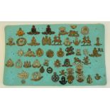 Framed and mounted display of approx forty nine British military cap badges including Army Cyclist