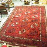 Caucasian pattern rust ground rug, central field with eighteen octagonal geometric pattern