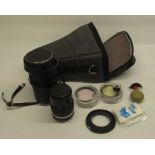 Nikon Nikkor 135mm 1:28 lens with individual black case, lens parts and a grey carry case