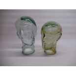 Two moulded glass phrenology type heads, H26cm and H30cm (2)