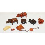 Collection of carved wood netsuke modelled as oxen and crabs, and a display stand, (7)