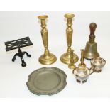 Collection of metalware incl. a school bell, two pairs of brass candlesticks, cast iron hearth