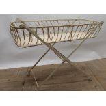 Early C20th folding wrought steel baby changing stand on marble casters, W49cm D104cm H80cm