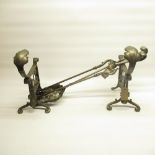 Pair of C20th cast iron fire dogs, with leaf cresting on scroll supports, similar poker and