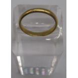 9ct yellow gold plain wedding band, stamped 375, size U, and another yellow metal ring with worn