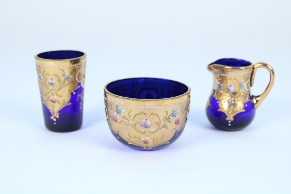 Early C20th Bohemian blue glass and gilt enamel miniature jug, bowl and beaker set in the manner