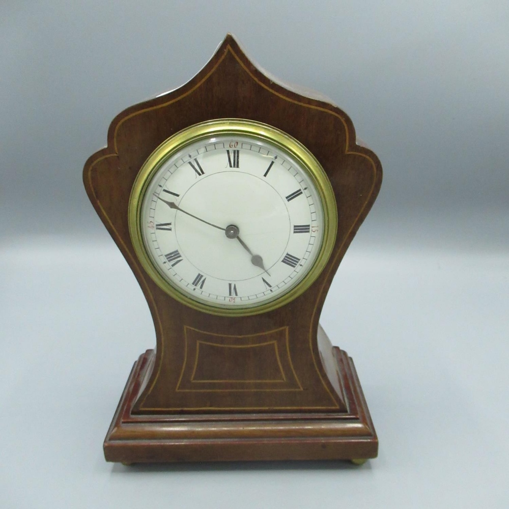 Edwardian inlaid mahogany balloon time piece, with brass bezel and white enamel dial, on bun feet,