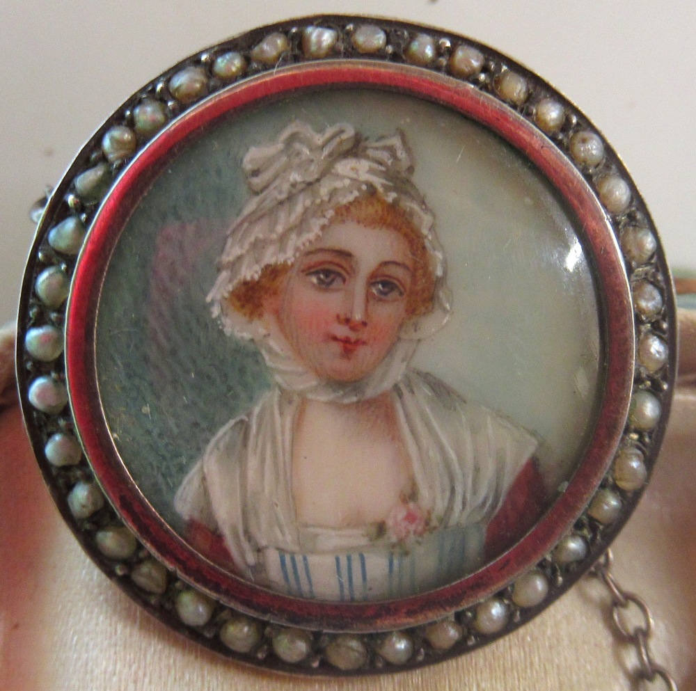 Late C18th yellow metal brooch set with portrait miniature of a young woman, with seed pearl