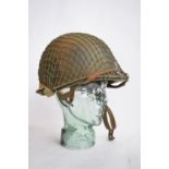 A US Army WWII M1 Mk1 front seam steel helmet, with liner, chin straps etc.