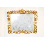 Late C19th French Rococo mirror, rectangular plate in pierced C scroll gilt wood frame, with