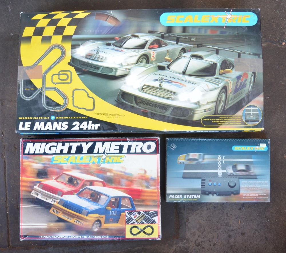 Collection of Scalextric track, Mighty Metro set with cars and a boxed Pacer system. See photos