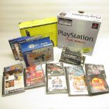 Boxed Playstation and Playstation 2 consoles with controllers, boxed Playstation controller, and Two