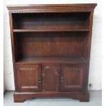 C20th oak open bookcase, adjustable shelf above two panel doors on bracket feet, W85cm D26cm