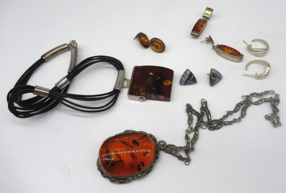 Sterling silver pendant set with amber, stamped 925, on white metal chain with leaf and fruit