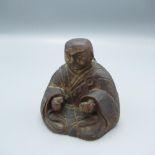 C20th oriental carved wooden incense burner in the form of a man meditating, signed with character
