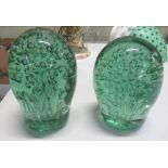 Pair of Victorian green glass end of day dump paperweights with internal bubble decoration,