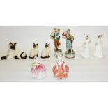 Three Beswick Siamese cats, two Capodimonte figures, and four Royal Doulton female figurines: 'Goody