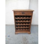 Oak 25 bottle wine cabinet, single drawer above five pull out racks, on bracket feet, W60cm D37cm