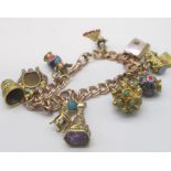 9ct yellow gold bracelet, stamped 9ct, with ten attached Victorian and later yellow metal charms