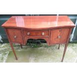 C20th serpentine mahogany kneehole sideboard with crossbanded top on square tapering legs with spade