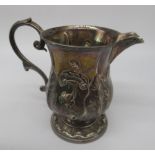 Victorian cream jug with repousse decoration and acanthus scroll handle on circular foot, makers