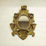 C19th gilt wood and gesso Rococo style wall bracket, oval mirror with rope twist surround, W32cm