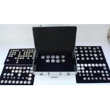 Aluminium coin carry case containing five trays of collectable £1, £2, 50p, mixed pre-decimal US and