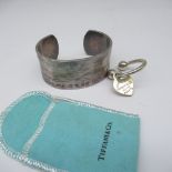 Silver cuff bracelet stamped T & Co. 925, Tiffany & Co. 1997 and a silver horseshoe keyring