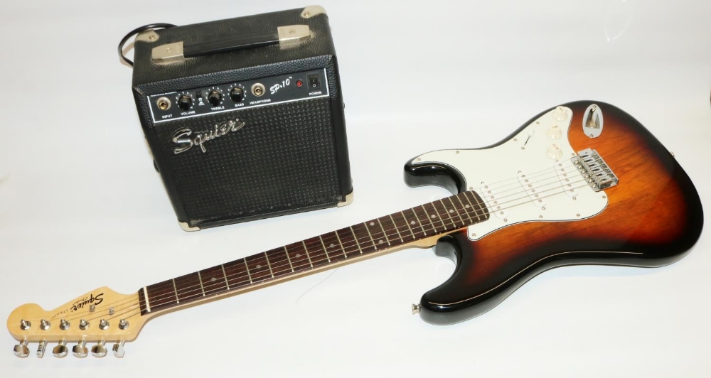Fender Squier Strat. electric guitar, sunburst finish, and Squier SP.10 230v practice amp, in
