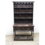 C20th oak dresser, with shelved back above long drawer on barley twist supports joined by an