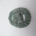 Jade carved pendant with Foo dog surrounded by shield border, with certificate of identification