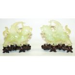 Pair of C20th Chinese carved jade Pixiu winged lion figures, L12cm, with carved wood display stands,