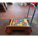 Tri-ang baby walker with twenty-four coloured wooden blocks