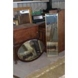 An Edwardian mahogany framed ovel bevelled edge mirror with egg and darts border W89cm X H59cm and a