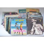 Collection of musical CDs and vinyl records including folders of singles. Artists include Queen,