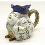 C20th French faience Toby style jug, portly gentleman wearing floral jacket, H17.5cm