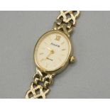 Ladies Accurist 9ct gold quartz wristwatch, signed oval champagne dial with baton and Roman indices,