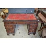 C20th Mahogany twin pedestal desk with inset red leather tooled and gilded writing surface with