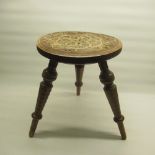 Victorian turned wooden stool, dished top with scroll and floral decoration on three out splayed