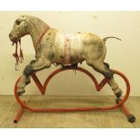 Vintage Tri-ang metal rocking horse, with painted detail on tubular stand, W114cm H95cm, and a fibre