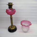 Late Victorian paraffin oil lamp, with cranberry coloured reservoir, cranberry tinted acid etched