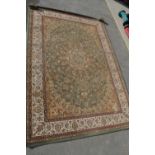 English Manor traditional pattern green ground acrylic rug with central medallion and floral pattern