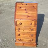 Small contemporary pine bureau, fall front above four long drawers, with turned wooden handles on