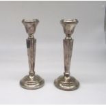 Pair of ER.II hallmarked Sterling silver candlesticks, tapering column on weighted base, by